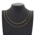 Double layer gold titanium necklace with white enamel accents on black velvet mannequin - White
