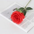 Single red velvet artificial rose with green leaves on an open book for home decor - Round Silk Red