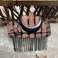 Detail of pink and black amethyst raw stones hand-wired to a black crescent moon hair comb - Rhodochrosite Black Moon