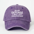 Detailed close-up of purple washed cotton baseball cap with white slogan embroidery - Purple