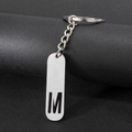 Sleek silver stainless steel keychain featuring a hollowed-out letter M pendant charm - Letter M