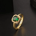 Vintage gold open ring featuring a round emerald green zircon with a halo of white stones - Round Green Stone Halo Style