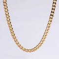 Macro view of polished golden cuban chain necklace with classic curb links and metallic luster - 5mm Gold