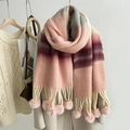 Close-up of rainbow mohair scarf featuring soft pink pom-poms and gradient knit texture - Pink