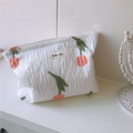 Detail of tulip floral embroidery and pleated fabric texture on a white cosmetic bag - White Tulips