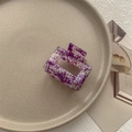 Close-up of a rectangle purple marble hair claw clip on a ceramic plate for styling - Small Square Claw / Floral Purple