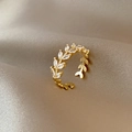 Golden laurel leaf open ring with marquise-cut zircons on elegant beige silk fabric - Laurel Leaf Gold