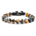 Detailed macro view of 10mm tiger eye beads and engraved metal plaque on a woven bracelet - Dreamy Tiger Eye Bracelet