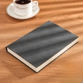 Classic A5 black leather notebook with refined texture on an elegant wooden desktop - Ruled / A5-Black