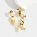 Close-up of elegant gold spiral drop earrings on white satin background with soft shadows - Wave Style