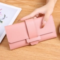 Pink faux leather long tri-fold wallet for women with snap closure and wood texture background - Pink