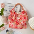 Detail of floral canvas tote bag showing striped handles and secure metal button closure - Summer Floral