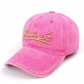 Detailed close-up of gold Bourbon St. embroidery on a vintage washed pink cotton baseball cap - Rose Red