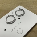 Silver hoop earrings with sparkling pave-set zircons on white display card - Minimalist Earrings / Silver