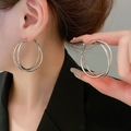 Fashionable twisted geometric silver hoop earrings shown on model in a stylish studio shot - 23# Silver Earring Post - Silver - Double Hoop - Medium