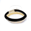 Detail shot of the elegant black and gold oval hair claw clip with sparkling rhinestones - Black