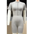Detail shot of grey ribbed seamless fitness jumpsuit with a half-zip neckline - Brown