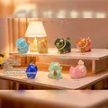 Gilded resin cat figurines in blue and gold with pearl necklaces on a display stand - -101 A Lifetime Of Carefree Golden Cats (6 Items) / Full Set