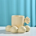 Beige ceramic paw-shaped handle mug with matching paw-print saucer set in speckled finish - Cat Claw Cup & Saucer - Apricot