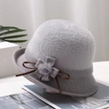 Detail of grey knitted cloche hat featuring decorative flower with a pompom and brown ribbon - Flower / Gray