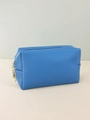 Detailed close-up of blue textured PU leather makeup bag with premium gold double zippers - Blue