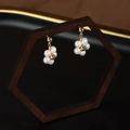 Floral cluster pearl earrings with gold-plated finish on a minimalist wooden frame - Flower Pearl Dangle Earrings