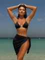 Detail of black textured bikini top and matching sarong set on a sun-drenched beach - S / Black