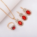 Golden bridal jewelry set with red oval gemstones and diamonds featuring ring and earrings - Three-Piece Set / Oval Red