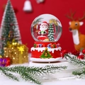 Close-up of a musical Christmas snow globe with Santa Claus and a red carved base - Large With Light Music/Style 4