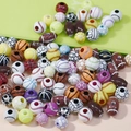 Macro view of assorted sports ball acrylic beads including football, basketball and tennis - Mixed Styles Mixed Colors Ball Beads