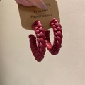 Detail of dark red woven leather C-shaped earrings with intricate handmade texture - Silver Earring Post - Red