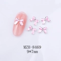 Détail de bijoux d'ongles nœud rose avec bordures en métal argenté taille 9x7mm - Nœud Bordure Argentée Rose Clair (8469)