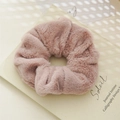 Detail of soft faux rabbit fur scrunchie in light pinkish brown on a notebook - Faux Fur Taro Purple