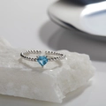Close-up of S925 silver heart ring with blue topaz gemstone on textured stone surface - Natural Topaz (LR267) / Silver