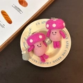 Handmade pink wool felt mushroom keychains with cute embroidery on a cream plate - Pink Mushroom Trio