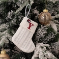 White knitted Christmas stocking with red letter Y embroidery on a snowy pine branch - Embroidered Knitted Small Sock White Y