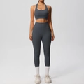 Detail of high-waist yoga leggings with functional side pockets and matching sports bra - Graphite Grey