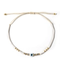 Handmade white seed bead bracelet with blue evil eye charm and adjustable woven cord - White