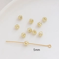 Close-up of 5mm hollow gold-plated copper beads and headpins for DIY jewelry making - 5mm / 14K Gold