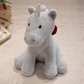 Unicorno di peluche grigio con corno d'argento e nastro satinato seduto sul tappeto - Grigio / 26cm
