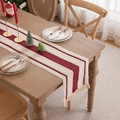 Woven linen table runner with red stripes and fringe tassels on a wooden dining table - 30x160cm (Includes Tassels) / Dark Red Triple Stripes