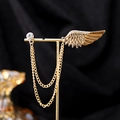 Elegant gold wing earring with tassel chains and crystals displayed on a golden stand - Gold