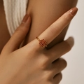 Detail of a gold floral ring featuring orange zircon clusters on a slim band for women - Adjustable Open / Orange Red (KR0041-1)