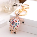 Detail of colorful crystal rhinestones on a gold turtle keychain with white enamel shell - Turtle 11 (Blue Pink Green)