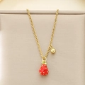 Macro detail of the golden chain necklace featuring a red strawberry pendant and gold bead - Double Pendant 3D Red Strawberry Gold Bead (KN292059-Z)