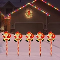 5-pack solar Christmas Santa garden stakes with candy cane poles and warm glowing lights - Style 3