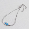 Close-up of sparkling adjustable Evil Eye bracelet with blue enamel and silver-plated chain - Platinum Plated - Sky Blue