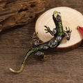 Vintage black enamel lizard brooch with grey rhinestones on a natural wooden background - Black Enamel and Gray Rhinestone