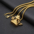 Detailed view of a polished gold crown pendant with a box chain on black leather background - Style B Gold / 60cm Box Chain