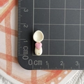 Close-up of mini resin spoon with pink heart, size 3.5cm shown on a measurement grid - Heart Spoon / Beige